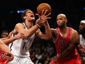 Brook Lopez (left) of the Brooklyn Nets is fouled by Taj Gibson of the Chicago Bulls during Game 7 of the NBA Eastern Conference quarterfinals May 4, 2013 at the Barclays Center in New York. (Elsa/Getty Images/AFP)