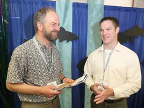 Arunas Liskauskus, management biologist with the Ontario Ministry of Natural Resources, Upper Great Lakes Management Unit chats with Jeff Gray, superintendent of the National Oceanic and Atmospheric Administration's Thunder Bay National Marine Sanctuary in Alpena, Mich. Both were presenters at the Sources of Knowledge Forum in Tobermory on the weekend (James Masters The Sun Times)