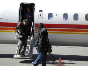 Residents of Kashechewan in northern Ontario arrive at Summerstown Airport on Sunday on their way to Cornwall, where they will be sheltered at the Nav Centre.
Erika Glasberg staff photo