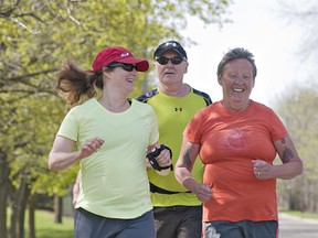Deb Steedman (right) is joined by Erika Melnyk and Lorne Alderson as she runs along Paris Road in Brantford on Sunday afternoon, May 5, 2013.  (BRIAN THOMPSON Brantford Expositor)