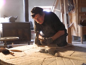 Many tasks have to be completed at the Upper Canada Village in Morrisburg before opening day for for the season. Frank Deguire, miller interpreter, redresses the stones that makes the flour at the Bellamy's Steam Flour Mill.
Erika Glasberg staff photo