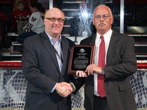 Ken Hodge, right, accepts a plaque from Portland Winterhawks president Doug Piper, when Hodge was inducted into the team's hall of fame.
Bryan Heim/Portland Winterhawks