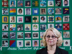 Jane Tucker, president of London Transplant Gift of Life Association, stands in front of a patchwork of stories of people and their heart. (DEREK RUTTAN, London Free Press)