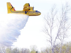 A file photo of a Ministry of Natural Resources water bomber dropping water on a bush fire near Sudbury in 2013.
GINO DONATO/THE SUDBURY STAR
