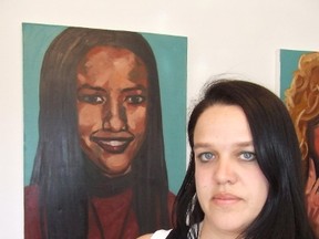Toronto artist Ilena Sova stands next to her portrait of Melanie Ethier, one of the 18 paintings in her The Missing Women Project now in display at the 276 Cedar studio. HAROLD CARMICHAEL/SUDBURY STAR/QMI AGENCY