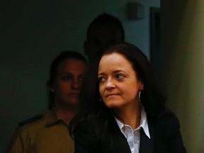 Beate Zschaepe, a member of the neo-Nazi group National Socialist Underground (NSU) enters the court before the start of her trial in Munich May 6, 2013. The surviving member of NSU blamed for a series of racist murders that scandalised Germany and shamed its authorities goes on trial on Monday in one of the most anticipated court cases in recent German history. The trial in Munich will focus on 38-year-old Zschaepe, who is charged with complicity in the murder of eight Turks, a Greek and a policewoman between 2000-2007, as well as two bombings in immigrant areas of Cologne, and 15 bank robberies.                REUTERS/Michael Dalder