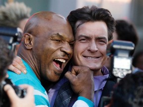 Actor Charlie Sheen poses with co-star former professional boxer Mike Tyson at the premiere of their new film "Scary Movie V" in Hollywood April 11, 2013. (REUTERS)