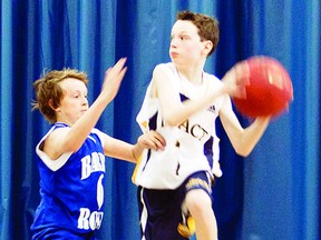 Kingston Impact’s U13 bantam boys basketball player Ethan Cahill looks for an open teammate before running over the baseline in a game against the Barrie Royals during the Ontario Basketball Provincial Championships. The championships were held at various recreation centres in Kingston from April 19-21. Kingston finished fourth overall in Division 5.    ERIC HEALEY - KINGSTON THIS WEEK