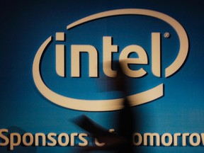 A woman walks past an Intel logo at the 2012 Computex in Taipei in this June 5, 2012 file photo. REUTERS/Yi-ting Chung/Files