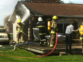 Firefighters from Station No. 4 Dover battle a house fire at 8286 Electric Line on Monday, May 6, 2013, north of Chatham, Ont.
(DIANA MARTIN/ THE CHATHAM DAILY NEWS/ QMI AGENCY)
