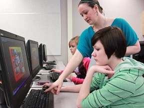 Tiffany Hemmingway, photography teacher, helps Chelsea Brunner and Kiana Yanke to completing their McDonald's tray liner designs for Education Week.
Celia Ste Croix | Whitecourt Star