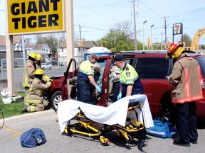 An elderly motorist is helped from his van Monday morning, May 6, 2013, after crashing into the base of a Giant Tiger sign while exiting the Tim Horton location on Lacroix Street in Chatham, Ont. Emergency crews were on scene to assist the driver and remove the disabled vehicle. The motorist wasn't injured although there were extensive damage to the front of the late model van.
BOB BOUGHNER/ THE CHATHAM DAILY NEWS/ QMI AGENCY