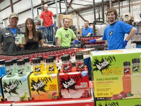 Owners Rob Kelly and Cathy Siskind-Kelly, left, stand in the production facility of Black Fly with employees Kyle Galloway, Shane Langley, Brent Dobbin and Phil Wiese at their plant in London on Monday. The makers of cocktail drinks are expanding due to strong sales. (CRAIG GLOVER, The London Free Press)
