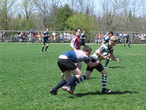 FLESHERTON – The St. Mary's Mustangs' Daniel Poirier hangs on to the Grey Highlands Lions' Travis Wright during the Lions 49-0 win on Monday in Bluewater Athletic Association senior boys rugby play.