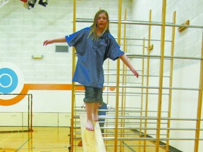 Tayler Kristiansen , a Grade 4 student, practises on a balance beam in gymnastics.