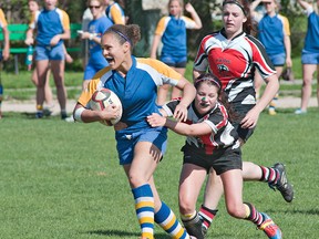 Sam Collins of Paris latches on to BCI ball carrier Manon Clarke during a high school senior girls rugby match on Monday afternoon at Paris District High School. (BRIAN THOMPSON, The Expositor)