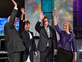 NDP leader Adrian Dix (2nd R), Green Party leader Jane Sterk (R), Conservative leader John Cummins (L) and Liberal leader Christy Clark react before their provincial election TV debate in Vancouver, British Columbia April 29, 2013. Voters go to the polls on May 14.  REUTERS/Andy Clark