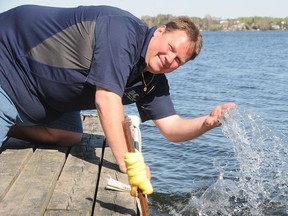 Sudbury Star ice guessing contest judge Scott Hodgins feels the water on Lake Ramsey on Monday afternoon, the ice offically left the lake at 7:50pm on April 30.

GINO DONATO/THE SUDBURY STAR