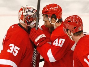 Detroit Red Wings' Henrik Zetterberg celebrates with goalie Jimmy Howard after defeating the Anaheim Ducks in over-time during Game 4 of their NHL Western Conference quarterfinals hockey game in Detroit, Michigan May 6, 2013. (REUTERS/Rebecca Cook)
