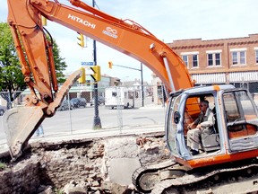 Victor Boutin, owner of the Everlast Group, works in a backhoe on Monday at the corner of Fourth and Wellington streets. His company has entered into a lease allowing the municipality to use the area as a paid parking lot on a temporary basis. BOB BOUGHNER bob.boughner@sunmedia.ca