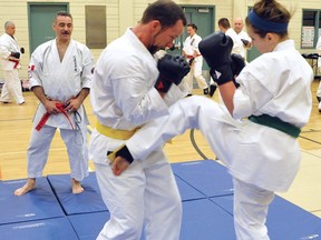 Hanshi Albert Mady looks on as Jay Cortvriendt, left, practices contact sparring with Matilda White, right. Mady spent the weekend in Kenora, grading black belts and instructing workshops to karatekas from across Northwestern Ontario and Manitoba.
HANDOUT PHOTO/David White