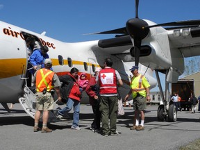 Evacuees from Kashechewan First Nations deplane at the Summerstown airport on Monday, May 6. Around 350 residents found a temporary home in Cornwall after their community was flooded.

CHERYL BRINK/CORNWALL STANDARD-FREEHOLDER/QMI AGENCY