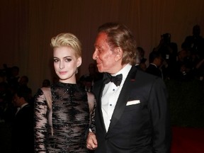 Anne Hathaway and fashion designer Valentino arrive at the Metropolitan Museum of Art Costume Institute Benefit celebrating the opening of "PUNK: Chaos to Couture" in New York, May 6, 2013.  (REUTERS/Carlo Allegri)