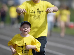 Sean Ingram jokingly chases his four-year-old son Cameron during the Steps for Life walk at the John Rhodes on Sunday. Steps for Life is to raise awareness about the importance of injury prevention in Canada. Many workers have been needlessly injured or killed on the job in the Algoma area over the years.