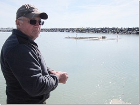 Joe Olah of South Cayuga was fishing at the Port Dover Marina on Tuesday morning in an area where an excavator sits submerged in the water. The excavator was dredging the channel on Monday at the time of the mishap.  MONTE SONNENBERG Simcoe Reformer