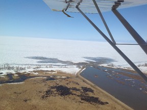 The north end of the Portage diversion appears narrow and partially filled with silt, while the water hits a thick layer of ice as it enters Lake Manitoba last week after the diversion was opened and proceeded to flood farmland along its route. (Kevin Yuill/Submitted photo)