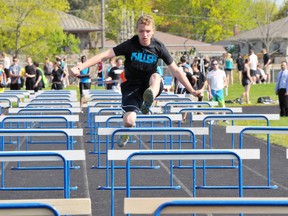 EDDIE CHAU Times-Reformer
Holy Trinity student Ryan Peters clears a series of hurdles during the school's track and field meet Tuesday morning.