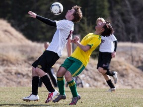 Canmore Crusaders striker John Lee, right, and a member of the Foothills Falcons look for control of the ball during a high school soccer game on Wednesday, May 1, 2013. The Crusaders won 9-1. Justin Parsons/ Canmore Leader/ QMI Agency