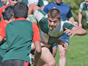 St. John's ball carrier Jacob LeBlanc tries to dodge North Park attackers during high school senior boys rugby action on Tuesday at George Jones Fields.(BRIAN THOMPSON, The Expositor)