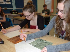 Lindsay Peloquin, left, a Grade 12 student at East Elgin Secondary School, and Alyssa Dimbleby, a Grade 11 student at Parkside Collegiate Institute, work with photographs of the planet Mars during a one-day SPARK symposium for gifted students held Tuesday at Parkside.