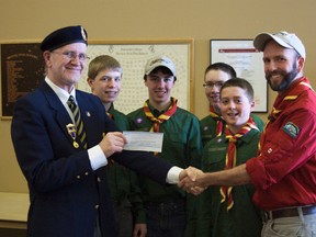 Ben Dart, treasurer of the Fairview Royal Canadian Legion, hads assistant Scout leader Jason Casselman of the Fairview Boy Scouts a donation in.