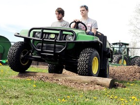 McGrail Farm Equipment's Jordan Lesy, left, instructs Chatham-Kent municipal summer student Cale Shepherd, right, around the John Deere Gator course which included obstacles, backing up, and dumping straw bales. The summer students working for the municipality's parks, recreation and cemetery division spent the day training on an assortment of tools and machinery they will be using throughout their contract. Photo taken Chatham, On., Tuesday May 07 2013 DIANA MARTIN/ THE CHATHAM DAILY NEWS/ QMI AGENCY