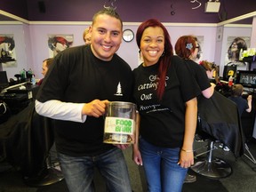 Dan Johnstone, a.k.a Can Man Dan, and Detailz Hair Salon owner Stephanie Tompkins pose for a photo during the first-ever Cutting Out Hunger event at Detailz Hair Salon (13708 Castle Downs Rd.) on Saturday. TREVOR ROBB Edmonton Examiner