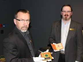 Sean Moir, the Royal Alberta Museum’s curator of military and political history, poses with assistant curator Anthony Worman at the museum last week with pieces from an upcoming exhibit highlighting Second World War prison camps in Alberta. KEVIN MAIMANN Edmonton Examiner