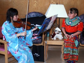 St. Thomas Aquinas exchange student and violinist Akari Tannaka attired in Japanese kimono and Ojibway jingle dress dancer Sigwan Copenace, 5, wore traditional dress in keeping with the international theme of the volunteer appreciation dinner at Pinecrest Home for the Aged, Tuesday, May 7.
REG CLAYTON/Miner and News