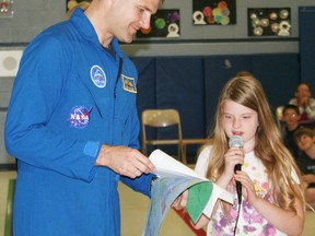 A student at Royal Roads Public School in Ingersoll presents Canadian astronaut Major Jeremy Hansen, who is a former Ingersoll resident, with a gift when he visited the school on Tuesday, May 7, 2013. One of the two most recent additions to the Canadian astronaut corps, Hansen anticipates he will be going into space within the decade. JOHN TAPLEY/INGERSOLL TIMES/QMI AGENCY
