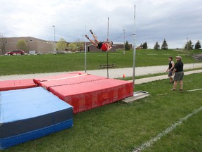 Ben Eppel, of OSCVI competes in the BAA boys pole vaulting final at OSCVI on Wednesday, May 08, 2013 in Owen Sound. looking on are fellow contestant Doug Miller 19, of OSCVI, center, and coach Don Bartley, right.