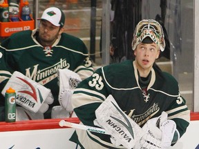 Wild goaltender Darcy Kuemper takes to the ice against the Blackhawks as Niklas Backstrom watches from the bench during Game 4 of their NHL Western Conference quarterfinal at the Xcel Energy Center in St. Paul, Minn., May 7, 2013. (ANDY KING/Reuters)