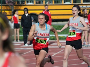 Emily Campbell, centre, takes over from Marika Fowler for the final leg of the 4x100m relay for LCCVI at the 17th annual St. Patrick's Invitational Track and Field Meet Wednesday, May 8, 2013 at St. Patrick's Catholic High School in Sarnia, Ont. (PAUL OWEN, The Observer)