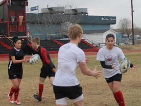 Members of the Father Mercredi Trappers men’s and women’s rugby teams run a New Zealand grid drill at practice Wednesday night. The Trappers rugby teams will kick off the season this weekend in Cold Lake.