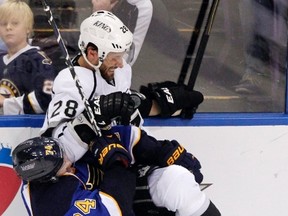 Blues forward T.J. Oshie checks Kings Jarret Stoll during Game 5 of their NHL Western Conference quarterfinal at the Scottrade Center in St. Louis, May 8, 2013. (SARAH CONARD/Reuters)
