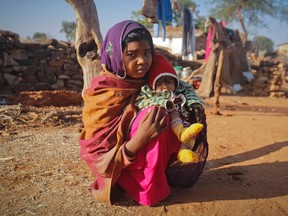 Krisha, 14, sits with her four-month-old baby Alok in her village in the northwestern Indian state of Rajasthan in this photo taken in January. She married her husband when she was 11. He was 13. The legal age for marriage in India is 18, but there, as in many parts of the world, early arranged marriages are fairly common. Any marriage under the age of 18 is a violation of the United Nations Convention on the Rights of the Child.