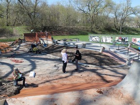 Paris Optimist Club skatepark committee member Bev Brooker shows a young skater the improvements to the park on Thursday, May 2, 2013 in Paris, Ontario. The upgrade adds 2,000 square feet to the park. MICHAEL PEELING/The Paris Star/QMI Agency