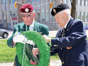 SEAN CHASE    Korean War veteran Bob Clarke (left) is assisted by naval veteran Wayne Petsnick during a wreath laying ceremony in Pembroke Wednesday to mark the 68th anniversary of Victory in Europe Day.
