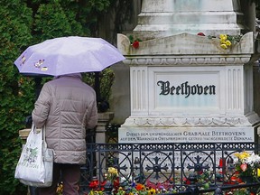 A woman pays her respect in front of the tombstone of German composer Ludwig van Beethoven at the central cemetery (Zentralfriedhof) in Vienna, on November 1, 2012. AFP PHOTO / ALEXANDER KLEIN
