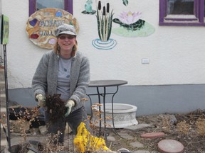 Mosaic’s Barb Curle was cleaning in front of the store and tidying up planters in front of the store.